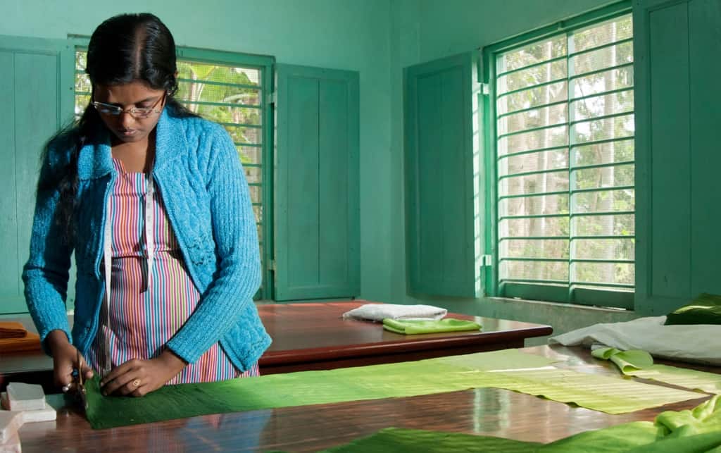 Cutting fabric at Kolkaghat SEWS