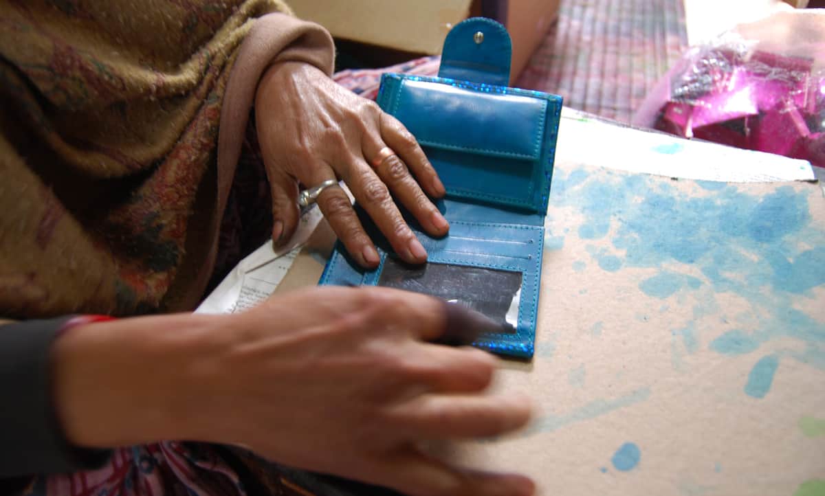 Assembling a leather wallet at Shanti Handicrafts