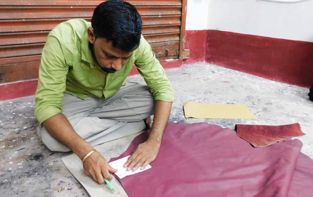 Using a pattern to mark out a piece of leather