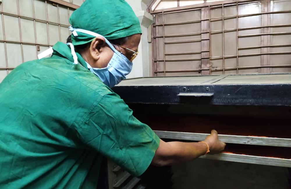 Worker at RASA production facility processing spices