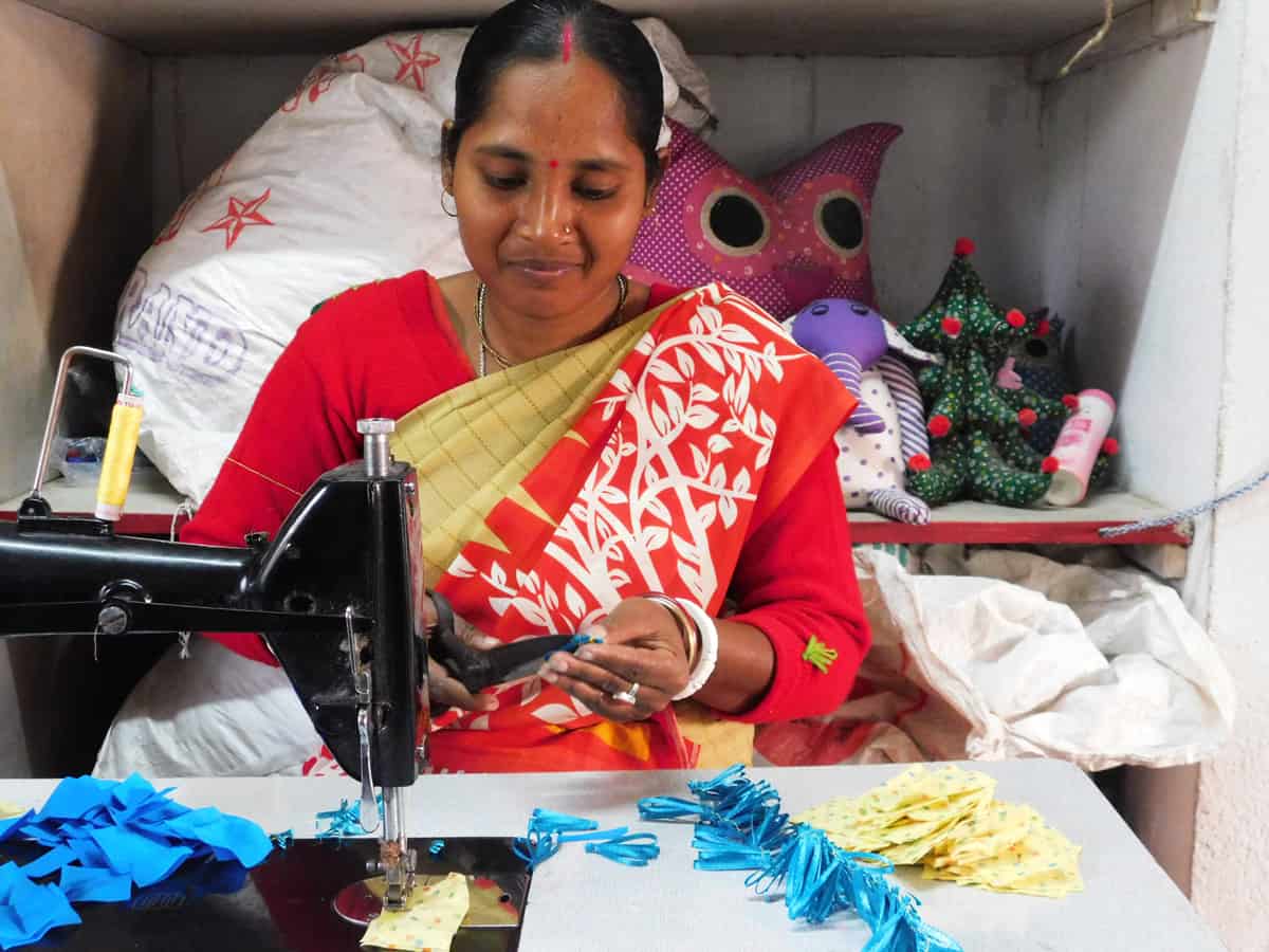 Woman working at sewing machine at Prachesta